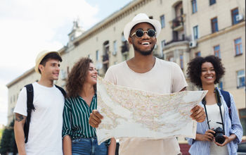 Travelers using a map to explore a city