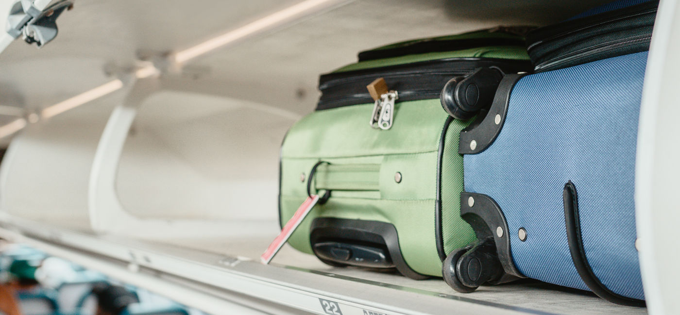 Image: Overhead bin on an airplane. (Photo Credit: Maridav/Adobe)
