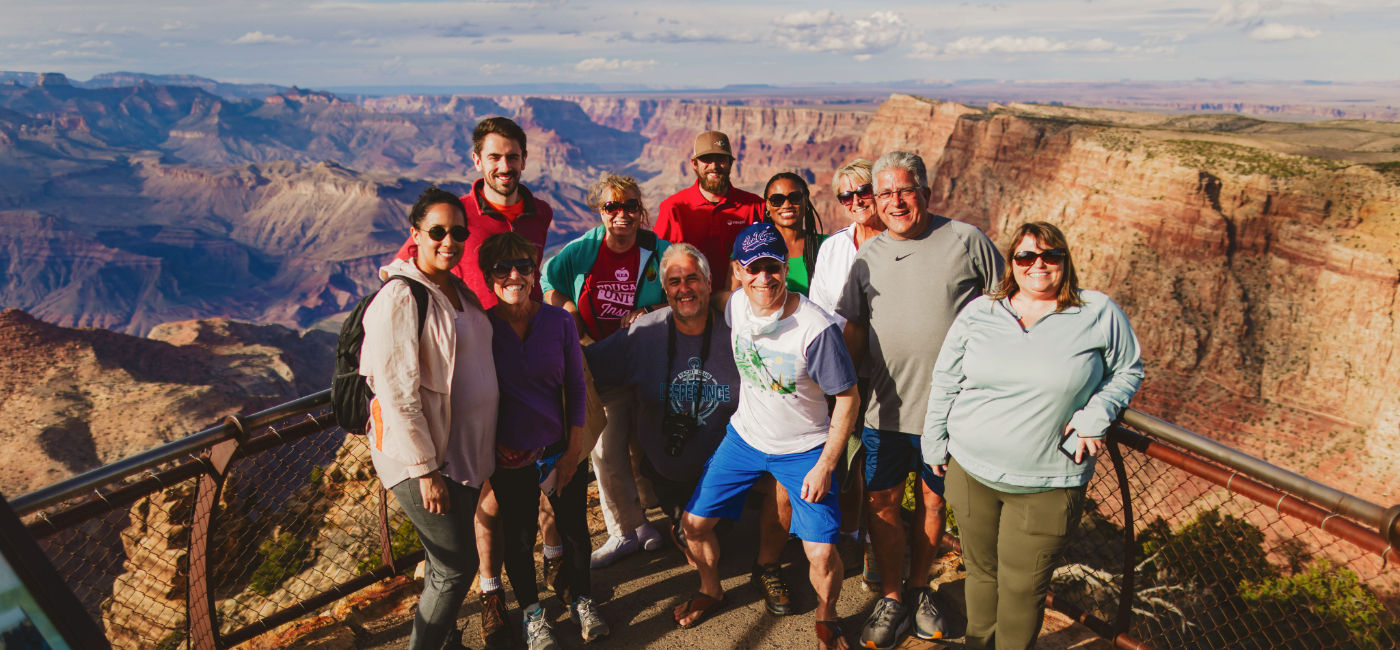 Image: An Intrepid Travel group posing in front of the Grand Canyon. (Photo Credit: Intrepid Travel)
