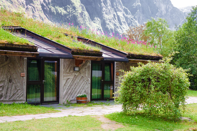 Hotel with ecofriendly grass roof and solar panels. Hotel with ecofriendly grass roof and solar panels.