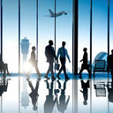 Corporate or business travelers walking through the airport.