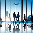 Corporate or business travelers walking through the airport.