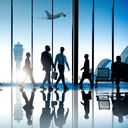 Corporate or business travelers walking through the airport.