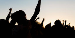 People holding fists up at a protest.