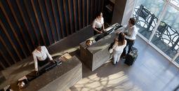 People checking in at hotel.