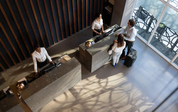 People checking in at hotel.