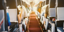 Airplane interior with passengers sitting in seats