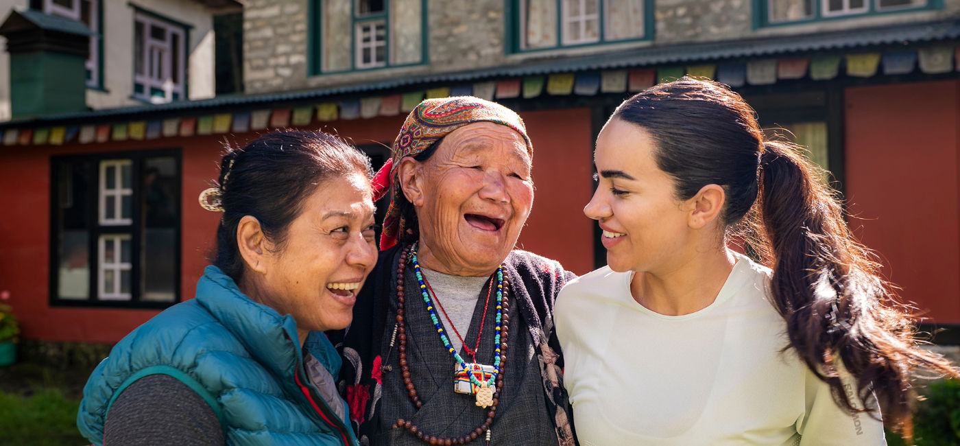 Image: A woman on a World Expeditions trip bonds with women in Nepal. (Photo Credit: World Expeditions)