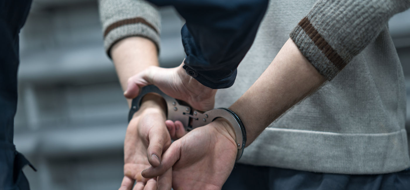 Image: Someone under arrest in handcuffs. (Photo Credit: Adobe Stock/vadimalekcandr)
