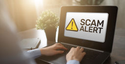 Scam alert displayed on a laptop computer.