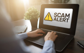 Scam alert displayed on a laptop computer. 