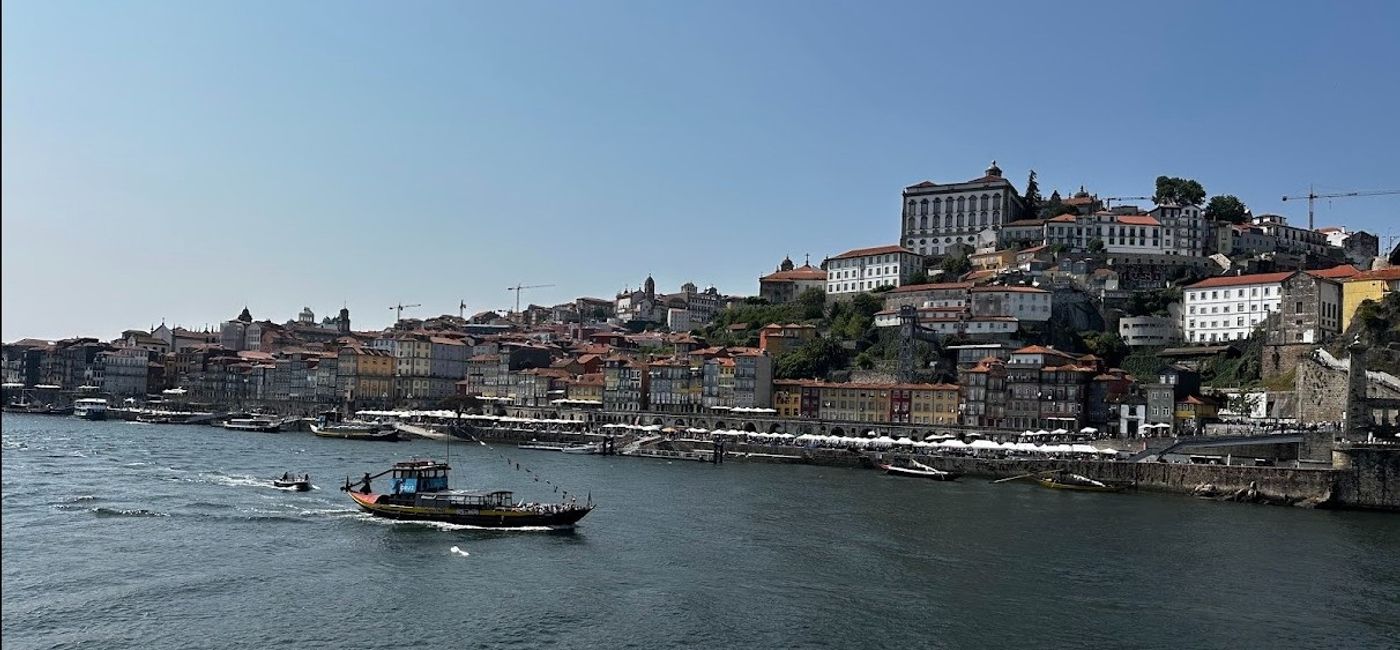 Image: Replicas of early wine transport boats called "rabelos" cruise the waters of the Douro River. (Photo Credit: Mikella Rutter)