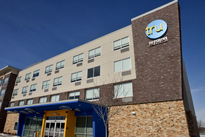 The exterior of a Tru by Hilton hotel. Hilton, Tru by Hilton