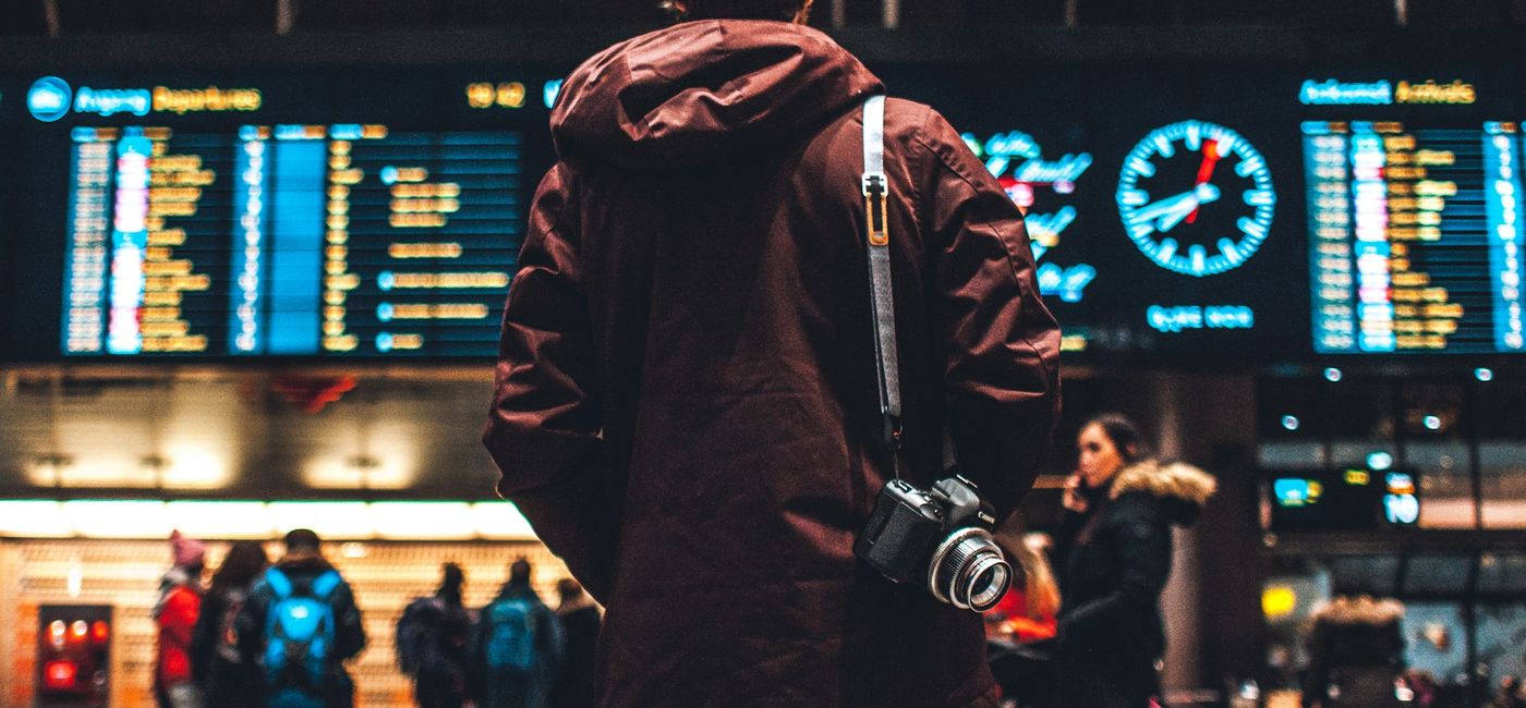 Image: Person checks the flight schedule (Photo Credit: Erik Odiin on Unsplash)