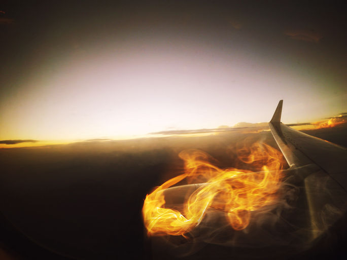 Flames of a burning airplane engine as seen from a passenger window. Flames of a burning airplane engine as seen from a passenger window.