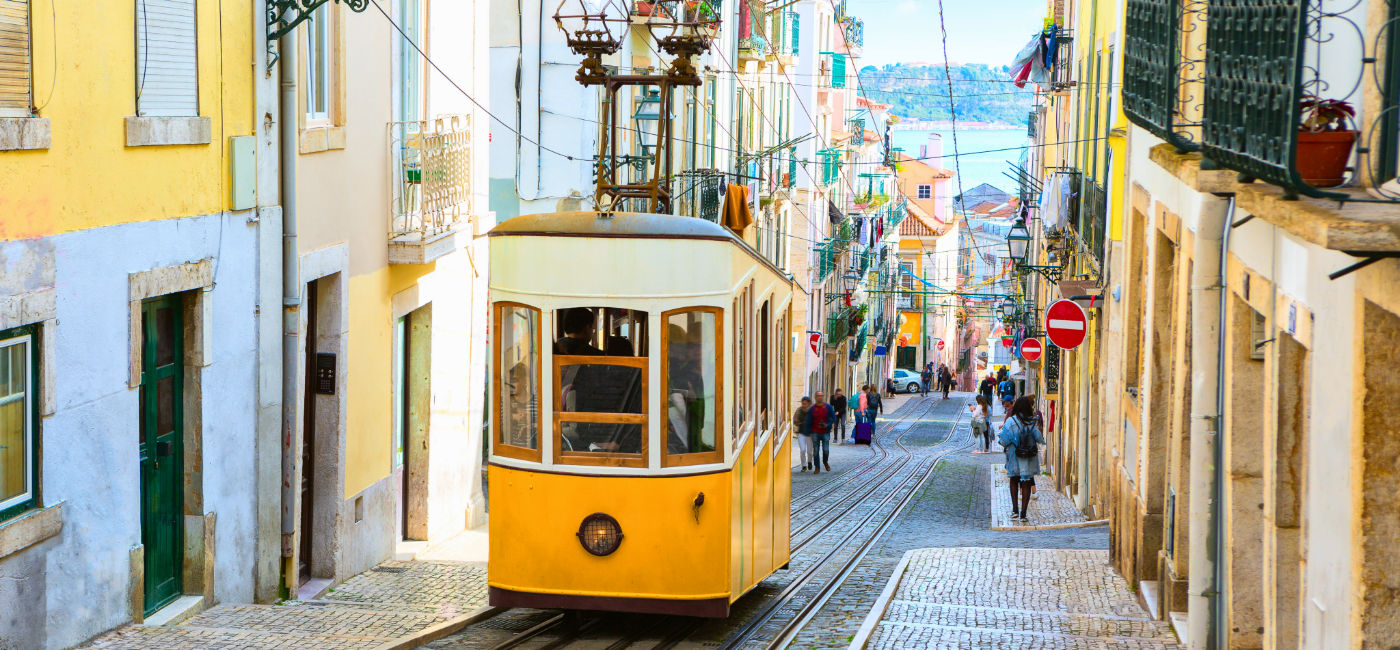 Image: The Bica Funicular rolls up a hill in Lisbon, Portugal. (Photo Credit: Antonel / Adobe Stock)