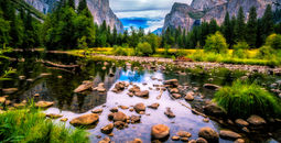View over the Merced River onto Yosemite National Park landmarks.