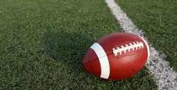 An American football at the fifty-yard line