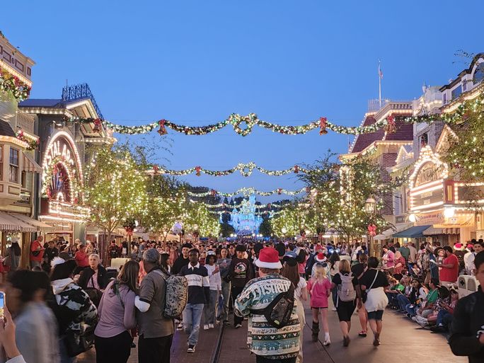 At dusk, the holiday lights illuminate Main Street USA and Sleeping Beauty's Winter Castle at Disneyland. Disneyland Resort, Main Street USA, Sleeping Beauty's Winter Castle, lights, holidays, seasonal, festive, decorations