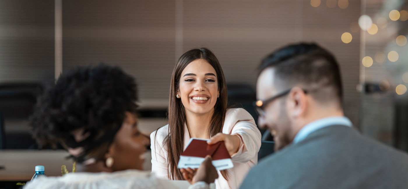 Image: Travel agent serving clients. (Photo Credit: Dragana Gordic / Adobe Stock)