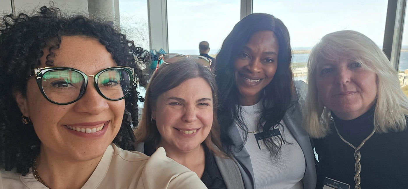 Image: Kelsie Marchetti (far left) poses with travel advisors at the Collette Roadshow. (Photo Credit: Collette)