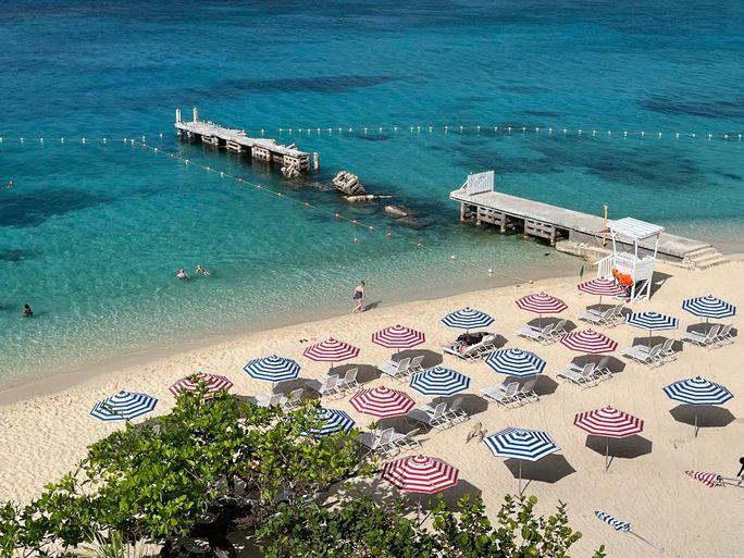 Striped umbrellas on the beach at S Hotel Montego Bay.