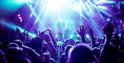 Crowd raising their hands at concert (Photo via bernardbodo / iStock / Getty Images Plus)