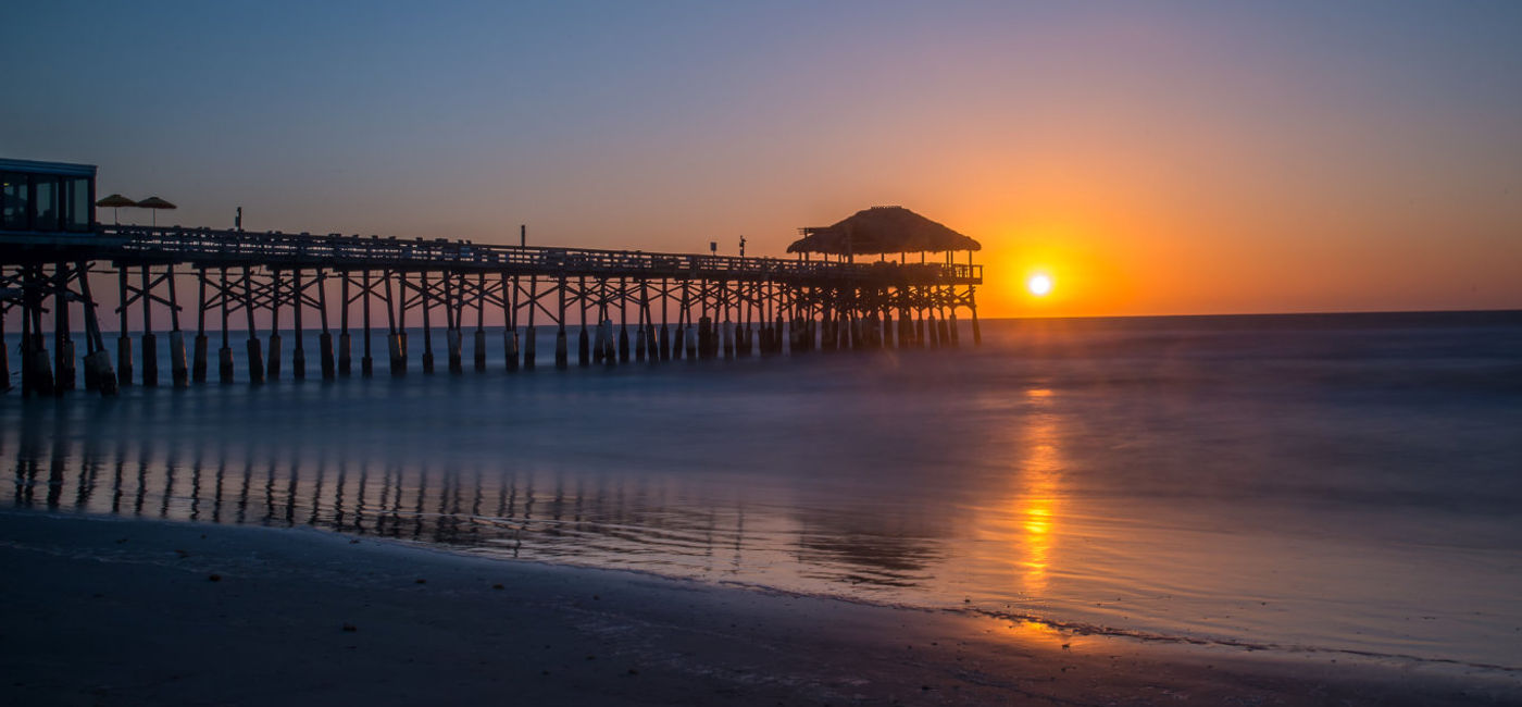 Image: PHOTO: Sunrise over the pier at Cocoa Beach, Florida. (photo via Flickr/Gregory Urbano)