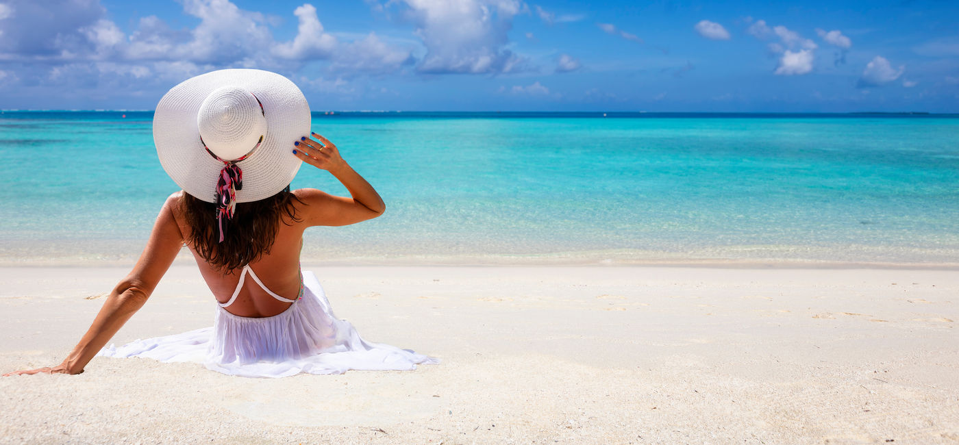 Image: Woman enjoying a Caribbean beach. (Photo Credit: moofushi/Adobe)