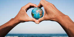 A young man with a world globe in his hands