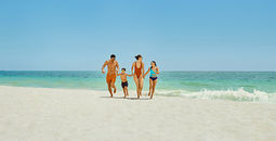 Family on the beach at the Grand Palladium Select Costa Mujeres