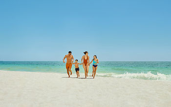 Family on the beach at the Grand Palladium Select Costa Mujeres