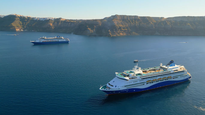 The Celestyal Journey and Celestyal Discovery sailing off the coast of Santorini. Celestyal, Celestyal journey, Celestyal discovery, boutique mediterranean cruise line, santorini cruises