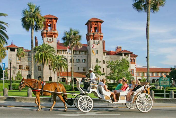 A horse-drawn carriage drives past the Lightner Museum in St. Augustine, Florida. St. Augustine, historic cities in America, second cities, historic towns in florida