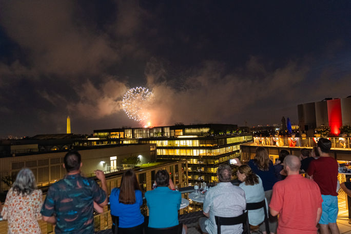 Guests watching July 4th fireworks from the Summit at Conrad in Washington, DC
