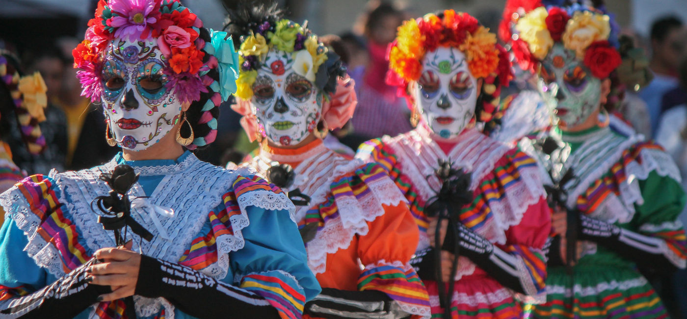 Image: Women celebrating Dia de los Muertos in Mexico. (Photo Credit: Brady/Adobe)