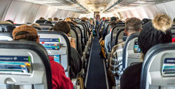 Passengers seated inside of a commercial passenger airplane.