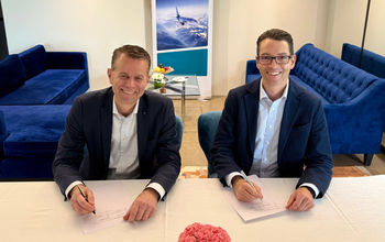 John Weatherill, WestJet EVP and CCO with Paul Verhagen, SAS EVP and CCO signing at the IATA AGM in Delhi, India