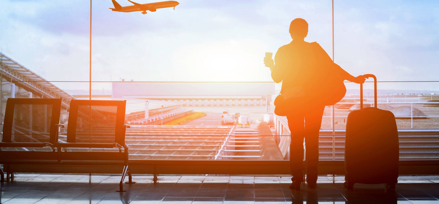 Image: Traveler awaiting flight at the airport. (Photo Credit: Song_about_summer/Adobe)