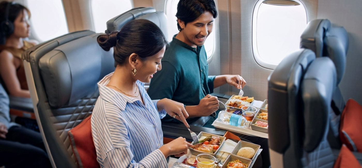 Image: A couple enjoys fresh meals in Singapore Airlines' Premium Economy Class.  (Photo Credit: Singapore Airlines)