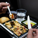 Airline passenger eats an in-flight meal