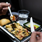 Airline passenger eats an in-flight meal