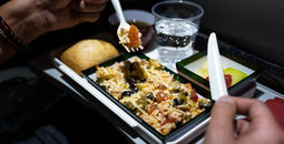Airline passenger eats an in-flight meal