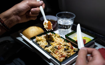 Airline passenger eats an in-flight meal