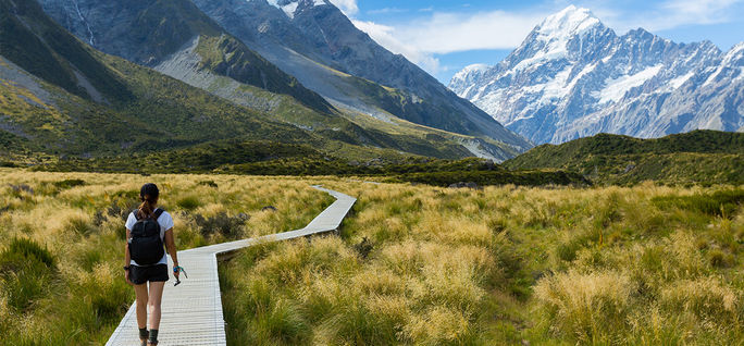 A woman hiking the Hooker Valley Track, New Zealand.