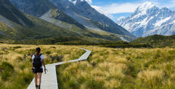 A woman hiking the Hooker Valley Track, New Zealand.