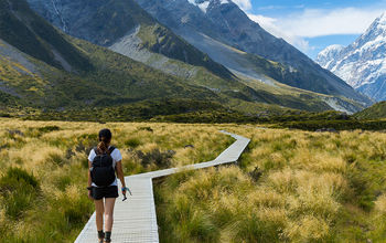 A woman hiking the Hooker Valley Track, New Zealand.