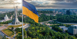 Ukrainian flag waving in the wind against the city of Kyiv, Ukraine