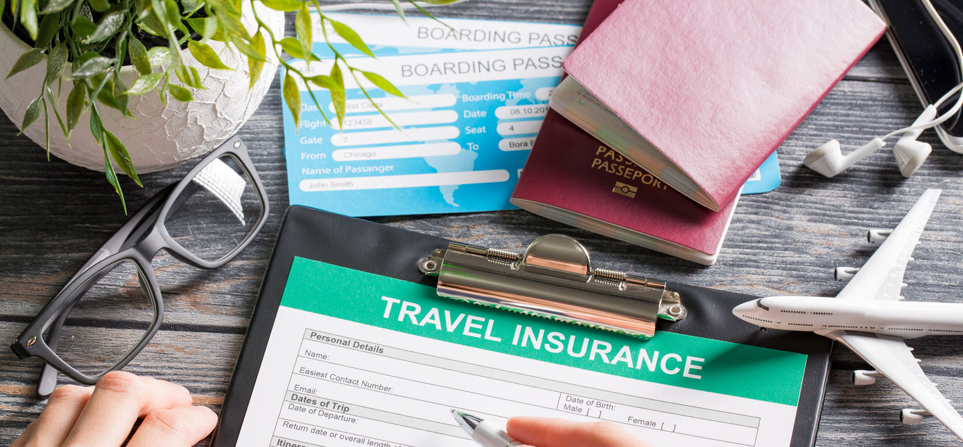 Image: Traveler purchasing an insurance policy. (Photo Credit: Adobe Stock/REDPIXEL)