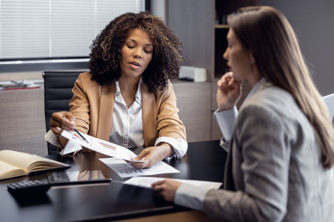 African-American travel agent working with client African-American travel agent working with client